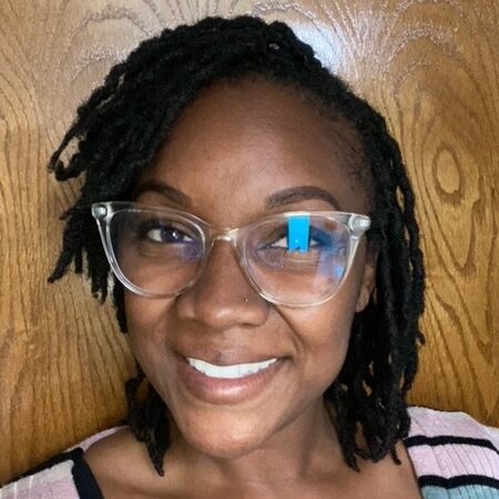 Picture of Jaima Owen in glasses, smiling at the camera.